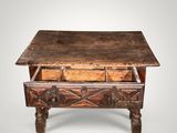 an old wooden table with a drawer underneath it