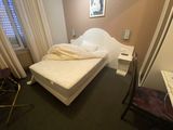 an image of a bedroom with a bed and a desk