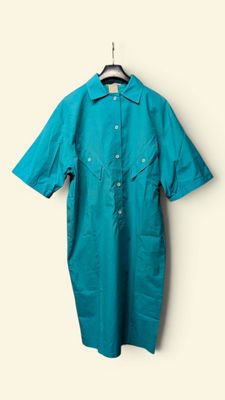 an image of a shirt hanging on a hanger on a wall