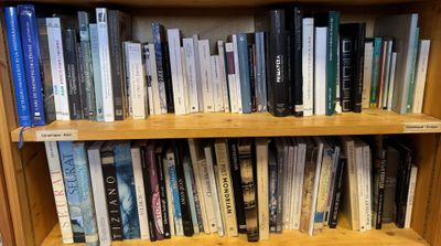 a book shelf with many books on it in a library