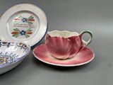 two cups and a saucer sitting on a table