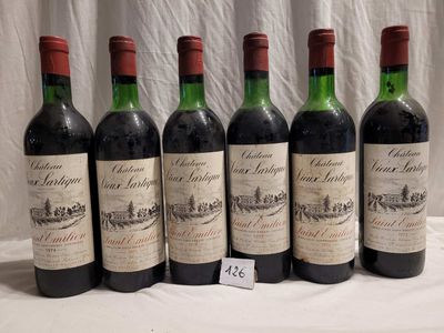 six bottles of wine are lined up on a table