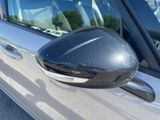 a side view mirror of a car with a reflection on the side of it