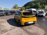 the yellow car is parked in the parking lot near many other cars