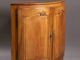 an old wooden cabinet with two doors and a drawer underneath it