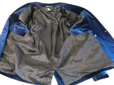 the back of a blue and grey jacket with a zipper on it