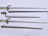 several different types of weapons are displayed on a white surface