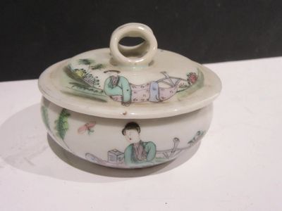 a small white bowl with a lid on a table