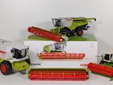 three different models of farm machinery are sitting on a white surface