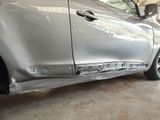 a silver car that has been dented and is parked in a garage