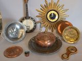 a table with a clock, a bowl, a plate, and other items on it