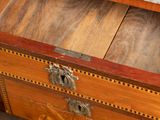 a marble top on a wooden chest of drawers