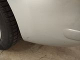 a close up of a white car with a flat tire