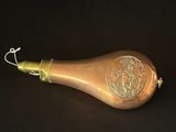 a small brass object on a black surface