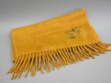 an image of a yellow scarf with fringes on a table