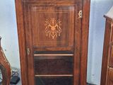 a small wooden cabinet with a mirror on top of it