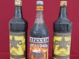 three bottles of beer are sitting on a red surface