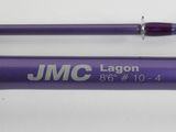 a close up of two purple fishing rods on a white surface
