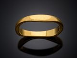a close up of a gold ring on a black surface