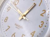 a close up of a white clock on a table