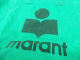 green shopping bag with a black logo on the front of it