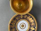 gold and blue cup and saucer with a gold rim