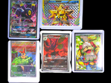 four different types of pokemon cards sitting on top of each other