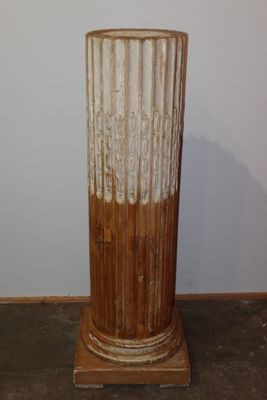 a tall vase that is sitting on a wooden stand