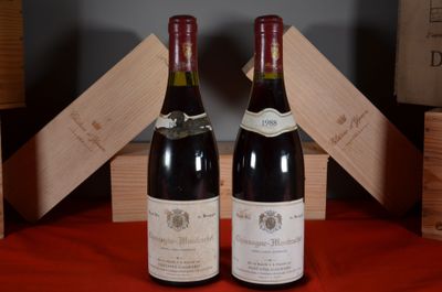two bottles of wine sitting next to each other on a table