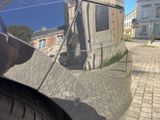 a reflection of a building on the side of a car