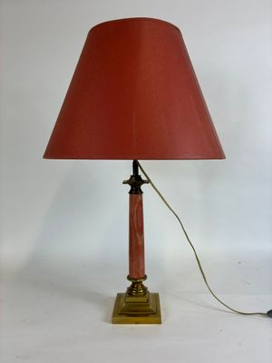 an image of a table lamp with a red shade on it