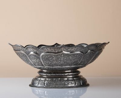 an image of a silver bowl sitting on top of a table