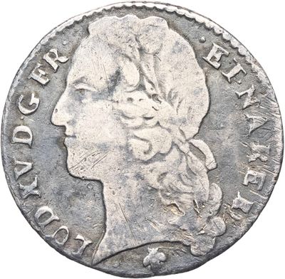 gros plan d'une pièce de monnaie sur laquelle figure une tête de femme