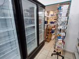 two refrigerators that are sitting in the middle of a store