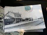 an old postcard with a picture of a train station on it