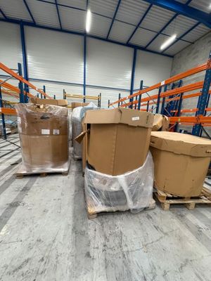 several boxes are stacked on pallets in a large warehouse