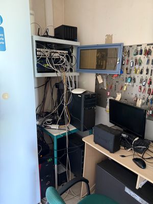 a desk with a computer monitor and a printer on it