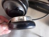 a person holding a pair of headphones in their hand