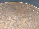 a close up of a metal plate with writing on it