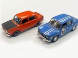 two toy cars sitting next to each other on a white surface