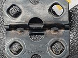 a close up of a metal latch on a black surface