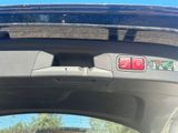 a close up of a car ' s dashboard with a red button
