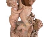 a statue of a boy and a girl holding a vase
