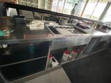 a man standing in a kitchen preparing food on the counter