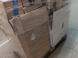 a man that is standing next to a pallet of boxes