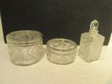 three glass jars sitting on a table next to each other