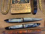 plusieurs types de stylos et d'autres objets sur la table
