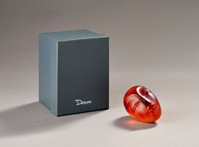a glass object sitting next to a box on a table
