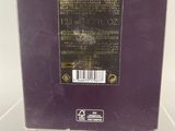 the back of a purple box with a black label on it