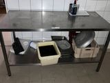 a metal table with a pot and pans on it